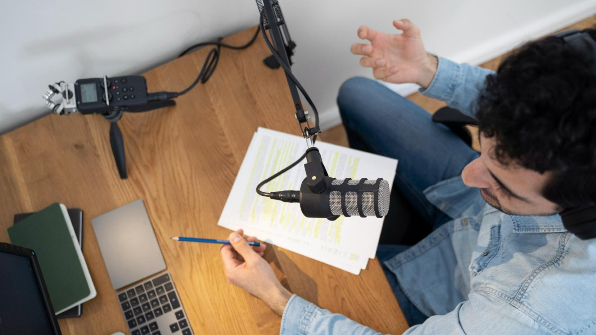 Man with microphone and headphones running a podcast in the studio